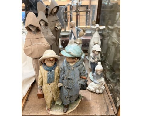 A Lladro figure "Away to School" depicting two children walking hand in hand in winter clothes, No.2242 together with Lladro 