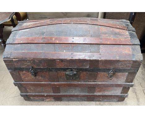 A domed trunk with wooden bands and metal ends