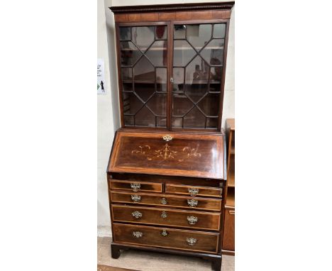 A 19th century mahogany bureau bookcase, the married top with a moulded cornice above a pair of astragal glazed doors, the ba