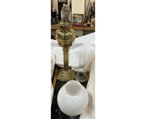 A Victorian Brass oil lamp with a square reeded column and square sloped base