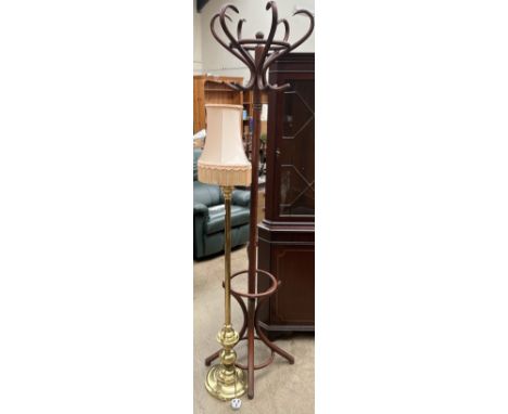 A bentwood hat and coat stand together with a brass standard lamp