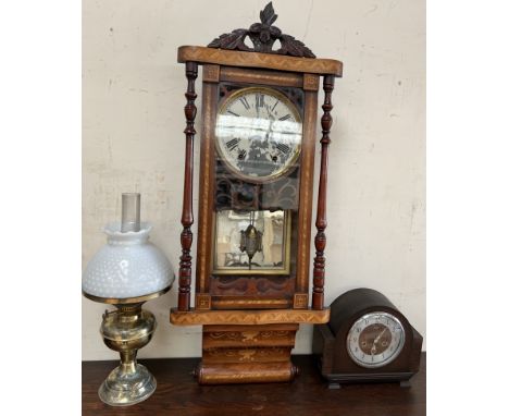 A drop dial wall clock together with an oak mantle clock and a brass and glass oil lamp