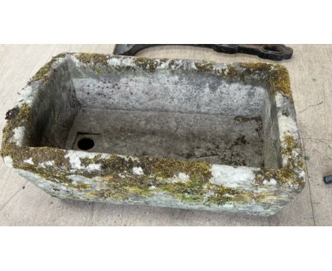 A weathered stone trough with D end and drain hole, approximately 80cm long x 47cm wide x 25cm high CONDITION REPORT: As is v