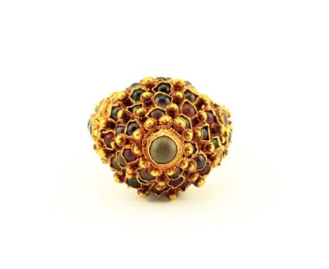 A gold pagoda or “princess” ring in the form of five tiers inlaid with rubies, emeralds and hessonite. The shank inset with a