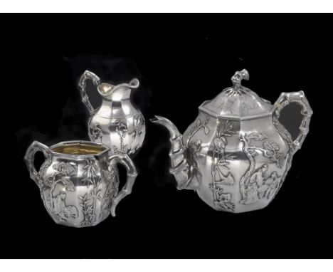 An octagonal 3-piece Chinese export silver tea set comprising octagonal teapot with personage bamboo and floral decoration wi