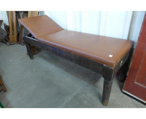A 1930's oak and upholstered examination bench