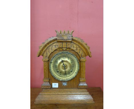 An early 20th Century American Ansonia oak mantel clock