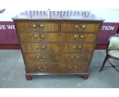 A fine George III mahogany chest of drawers, with canted reeded corners and two short over four long cockbeaded drawers havin