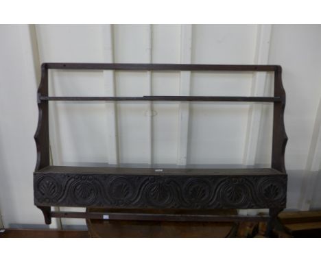 A carved oak wall shelf