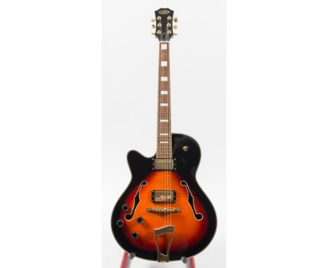 A  left handed semi- acoustic electric guitar by Stagg:, the ebonised headstock with gold plated keys over a rosewood fingerb