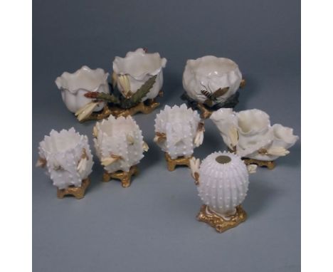 Two Moore Bros. porcelain centrepiece vases: one of flattened circular form on a scroll base applied with flowers and foliage