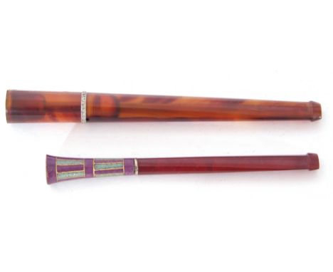 Mixed Lot: two long stemmed amber cheroot holders, one decorated with a coloured enamel end with chequered type design, large