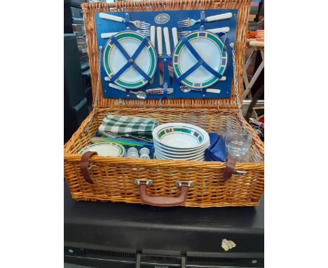 An Optima for John Lewis picnic hamper and contents to include additional picnic ware together with a black Delsey hard suitc