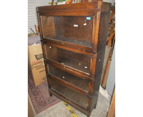 An early to mid 20th century oak four-section Globe Wernicker bookcase 159.5cm x 87.5cm x 29cm Location: 