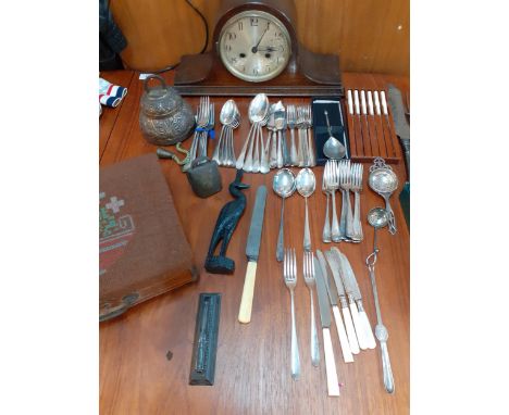 Silver plated and other cutlery and flatware, a mid 20th century oak cased mantel clock, two brass bells and other itemsLocat