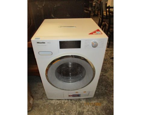 A Miele W1 Twin DOS and WiFi connect washing machine with spanner to release the drumLocation: 