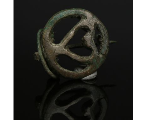 ITEM: Openwork fibulaMATERIAL: BronzeCULTURE: RomanPERIOD: 2nd - 3rd Century A.DDIMENSIONS: 33 mm x 30 mmCONDITION: Good cond