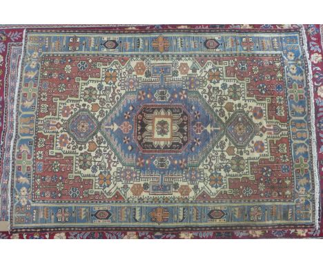 A North West Persian Nahawand rug, central diamond medallion with repeating petal motifs on an ivory field, within stylised f