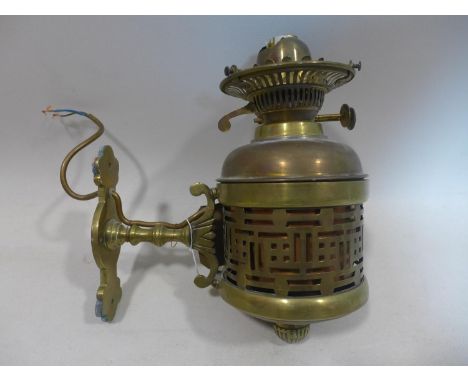 A brass wall mounted oil lamp, converted to electricity, H.28 D.25cm 