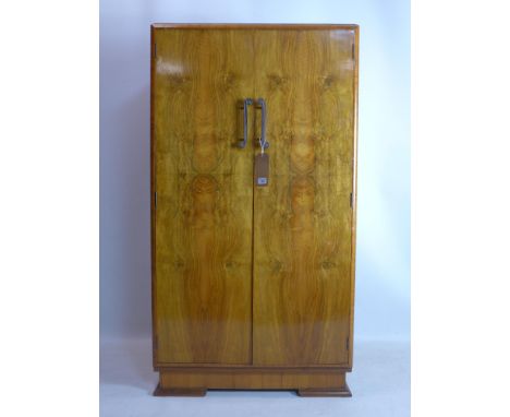 An Art Deco style walnut veneered cabinet, raised on bracket feet, H.142 W.77 D.47cm 