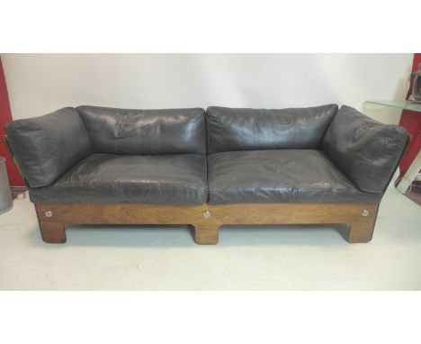 A 1970's Danish style exotic hardwood sofa by Pirelli Ltd, UK, with black leather upholstery and chromium bolts, H.67 W.205 D