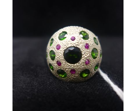 A sterling silver bombe-shaped ring set with 6 faceted rubies and 13 faceted green garnets, Size: R, 13.2g 
