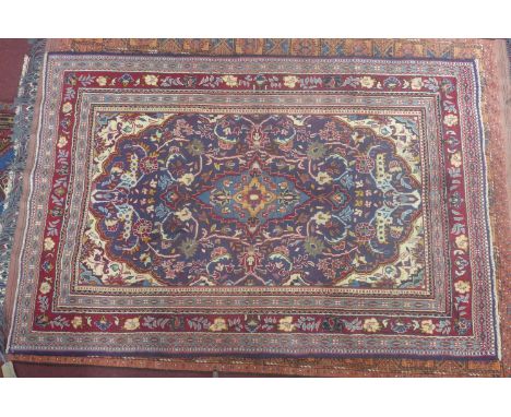 A North West Persian Lilihan carpet, central double pendent medallion with repeating spandrels on a sapphire field, within st