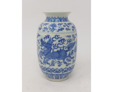 An early 20th century Chinese porcelain vase, hand-painted in blue and white with dragons amongst foliage, blue 6 character m