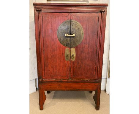 MARRIAGE CABINET, Chinese Qing dynasty, late 19th/early 20th century, scarlet lacquered with two doors enclosing shelf with t