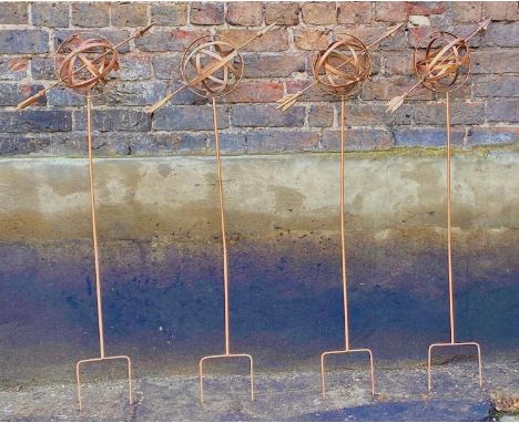 ARCHITECTURAL GARDEN ARMILLARY SPHERES, a set of four, on stakes, coppered finish, 115cm H. (4) 