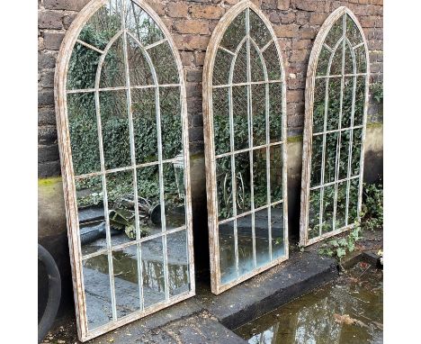 ARCHITECTURAL GARDEN MIRRORS, a set of three, arched tops, aged metal frames, 160cm x 67cm. (3) 