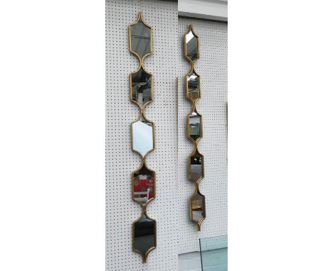 ARCHITECTURAL ACCENT WALL MIRRORS, a pair, gilt frames, 147cm x 14cm. 