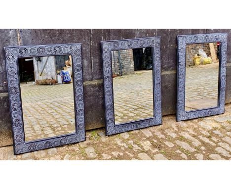 ARCHITECTURAL GARDEN WALL MIRRORS, a set of three, black painted Spanish style, 90cm x 63cm. (3) 