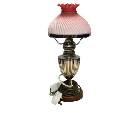 A silver plated table lamp, with a pink satin glass wrythen fluted shade, 41cm high. Condition - shade cracked, lamp untested