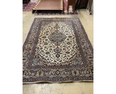 A Tabriz ivory ground carpet, 294 x 198cm. Condition - fair