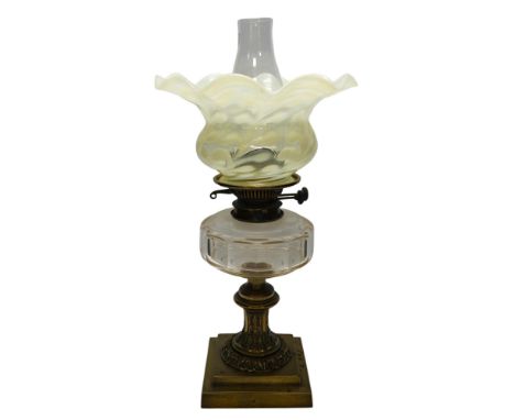 A brass oil lamp with glass reservoir and Art Nouveau vaseline glass fluted shade, 48cm high. Condition - good