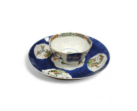 A Chinese famille verte powder blue ground bowl and a similar dish, both Kangxi period, 27.5cm diameter. Condition - dish poo