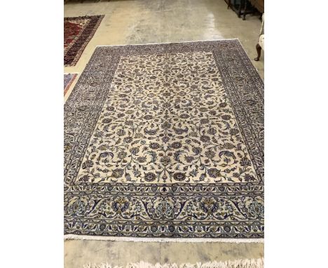 A Kashan ivory ground carpet, 390 x 274cm. Condition - good No damage or repairs. Does have some minor dirt stains and would 