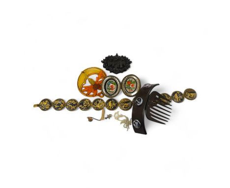 A French Bois Durci brooch, a French carved and stained horn pendant, a hair comb, ornate glass belt buckle and Japanese mixe