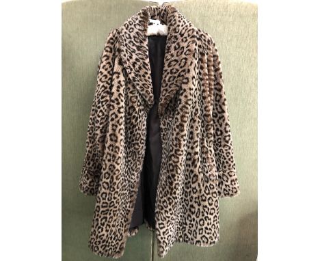 COAT: A NUAGE ANIMAL PRINT FAUX FUR COAT.