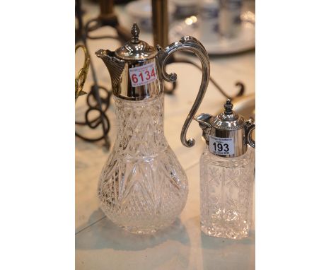 Two silver plated topped glass claret jugs, one with masked spout. P&amp;P Group 3 (£25+VAT for the first lot and £5+VAT for 