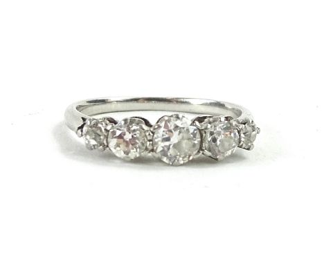 A five stone diamond ring, with design of graduated round brilliant cut diamonds, in claw settings, the central stone approx.