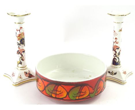 A pair of coal port Hong Kong pattern porcelain candlesticks, and a Poole Delphis bowl.