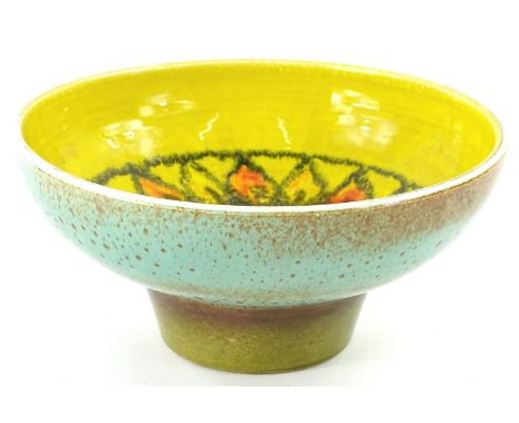 A 20thC Poole Delphis style bowl, centred with a flower head on yellow ground, polychrome decorated in orange, green and blue
