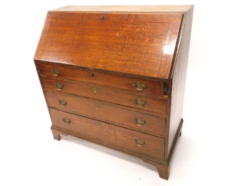A George III oak bureau, the fall enclosing a fitted mahogany interior above four graduated drawers brass handles and bracket