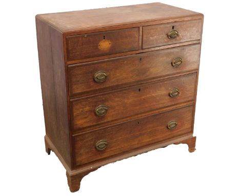 An early 19thC oak and mahogany cross banded chest of drawers, the caddy shaped top above two short and three long drawers, o