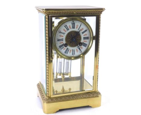 A late 19thC French brass four glass mantel clock, the enamel type dial with Roman numerals, the case with filigree border to