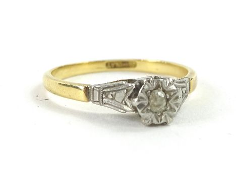 An 18ct gold and platinum dress ring, the raised platinum ring head set with tiny illusion set diamond, on an 18ct gold weddi