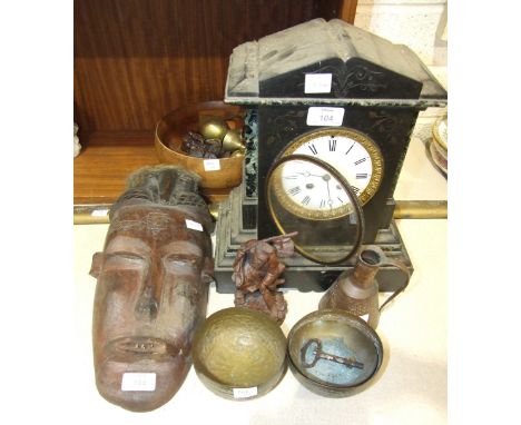 A black slate case striking mantel clock of architectural design, 34cm high, a carved tribal face mask, 40cm high and other w