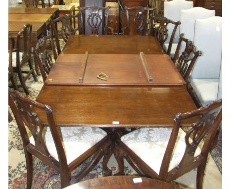 A set of eight reproduction mahogany finish Chippendale-style dining chairs with drop-in seats, on carved cabriole legs and c